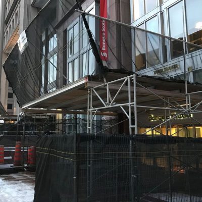 Black Scafnet covering a platform and fencing.
